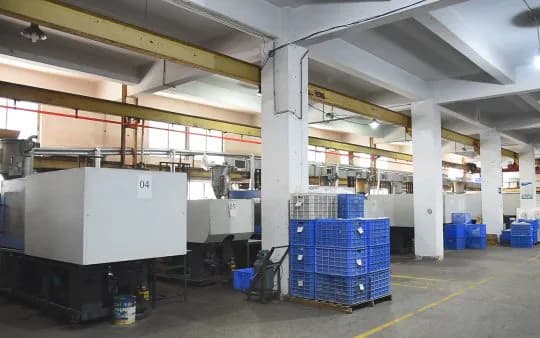 Production equipment, open work areas and storage bins in a factory photograph